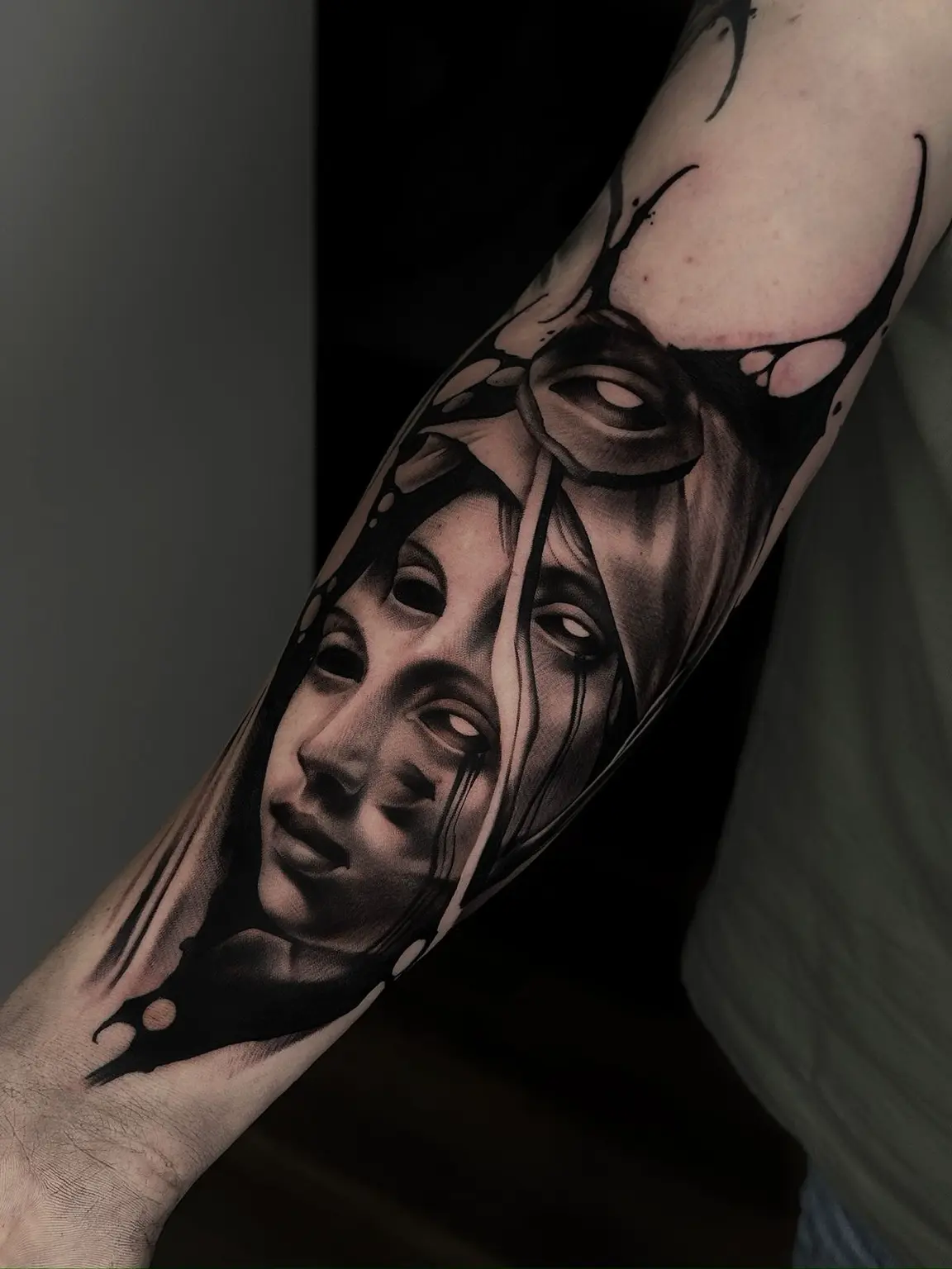 A layered black and grey composition built around portrait work and heavy negative space.